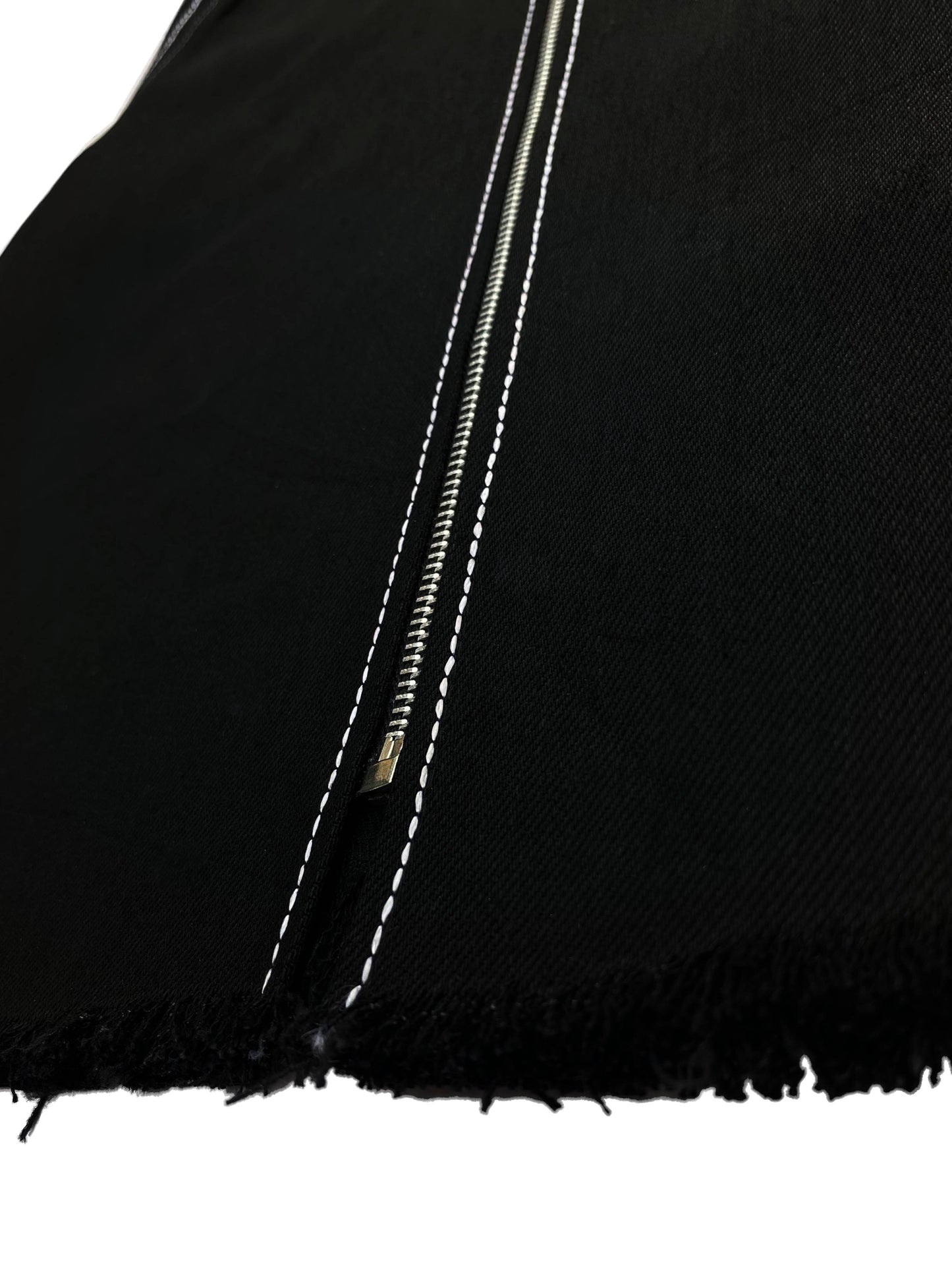 Close-up of a black fabric with a zipper detail on a white background